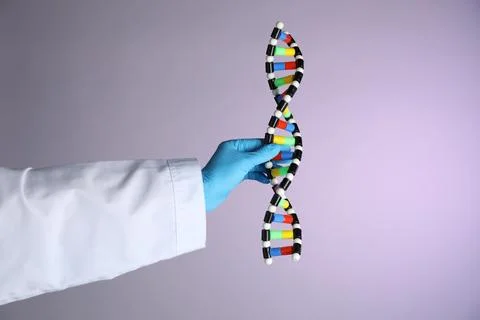Scientist with DNA structure model on color background, closeup Stock Photos