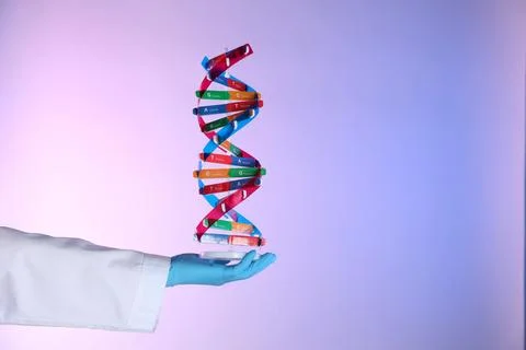 Scientist with DNA structure model on color background, closeup Stock Photos