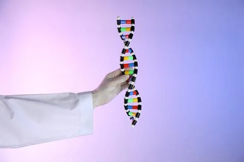 Scientist with DNA structure model on color background, closeup Stock Photos