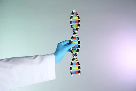 Scientist with DNA structure model on color background, closeup Stock Photos