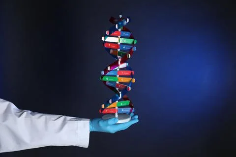 Scientist with DNA structure model on dark blue background, closeup 스톡 사진