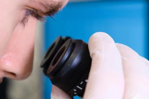 Scientist doing experiment with electronic microscope in scientific genetic Stock Photos