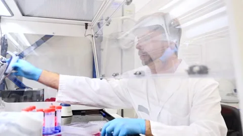 Scientist doing experiment in laboratory Stock Footage 255196453