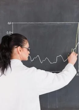 Scientist drawing a graph on the blackboard Foto stock