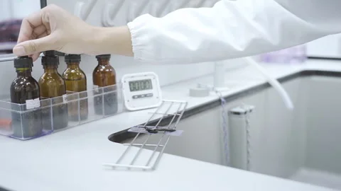 Scientist drop solution and start timer close up Video stock 247403968