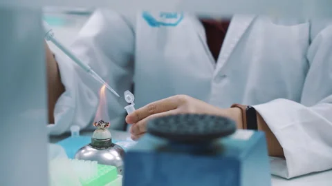 Scientist drop transparent solution to the small container and shake it Video stock 159244672