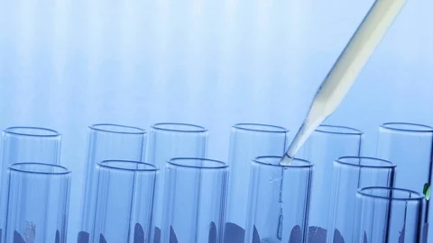 Scientist dropping chemical liquid or essential oil to test tube Stock Footage 125412082