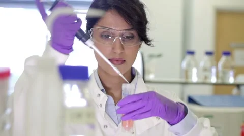 Scientist dropping liquid into vial in genetic laboratory Stock Footage 5096037