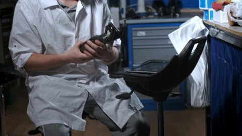 A scientist engineer is testing an electronic bionic prosthetic arm. He moves Stock Footage 120159698