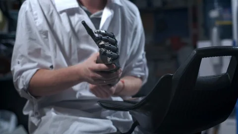 A scientist engineer is testing an electronic bionic prosthetic arm. He moves Stock Footage 120159715