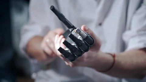 A scientist engineer is testing an electronic bionic prosthetic arm. He moves Видео 120164725