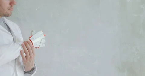 Scientist engineer is testing robotic prosthetic hand trying to move fingers Stock Footage 106222044