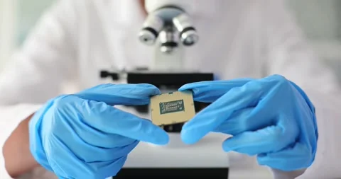 Scientist engineer using microscope to inspect motherboard microprocessor Stock Footage 255805991