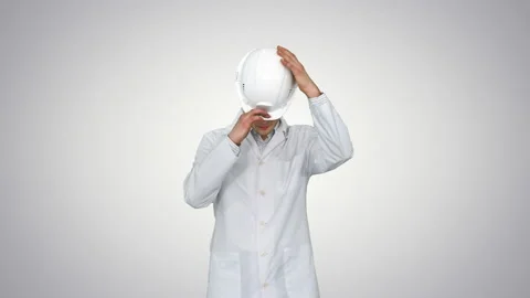 Scientist Engineer in white robe, safety helmet and glasses Making funny moves 스톡 동영상 130709596
