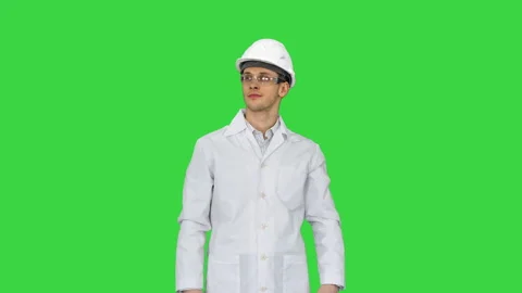 Scientist Engineer in white robe, safety helmet and glasses Making funny moves Stock Footage 139020787