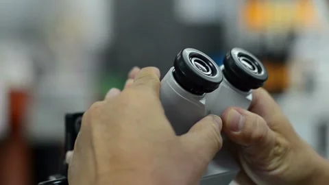 A scientist examines bone cells under a microscope, 2k cinematic footage Stock Footage 336583625