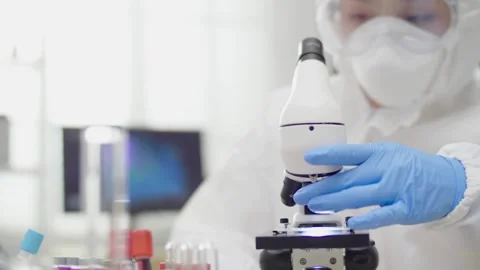 A scientist examines bone cells under a microscope, 2k cinematic footage Stock Footage 336583641