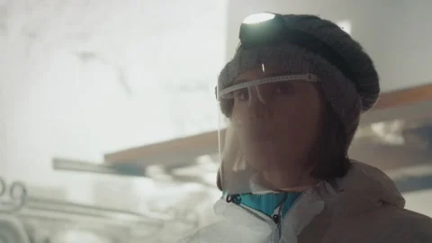 Scientist examines cautiously. Female scientist meticulously investigates Stock Footage 346474764