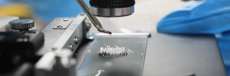 Scientist examines crystals under microscope in laboratory Stock Photos