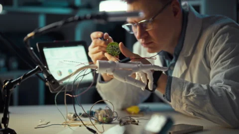 Scientist examines intricate circuit components while developing robotic tec Video stock 331297463