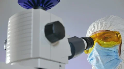 Scientist examines a sample of bacteria under the microscope. Stock Footage 106214657