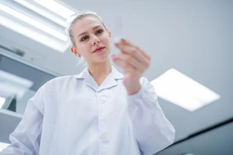 Scientist examines sample in laboratory during research session in modern f.. 写真素材