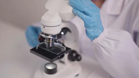 Scientist examines sample with microscope in laboratory research advanced t.. Stock Footage 333493403