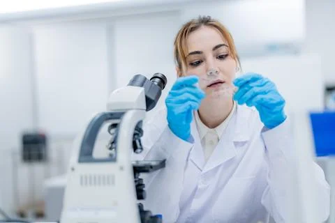Scientist examines samples in a laboratory using a microscope during a rese.. Fotos de archivo