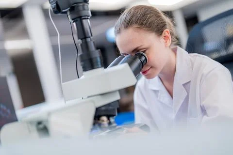 Scientist examines samples through a microscope in a laboratory setting dur.. Stock Photos