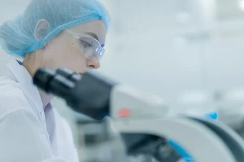 Scientist examines samples under a microscope in a laboratory setting durin.. Stock Photos