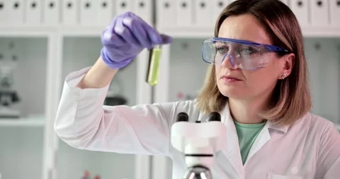 Scientist examines test tubes with crude oil and petroleum products Stock Footage 262861596