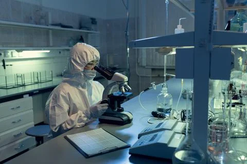 Scientist examining bacterium through the microscope 스톡 사진