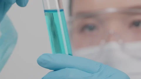 Scientist Examining Blue Chemical Solution in Test Tube, Laboratory Close-up 库存影片 335137384
