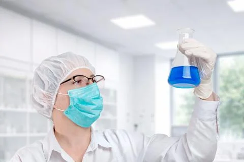Scientist examining blue liquid in flask, laboratory experiment and scienti.. Stock Photos
