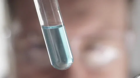Scientist examining blue liquid in test tube Stock Footage 35109629