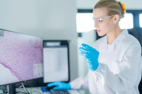 Scientist examining cell sample under microscope in laboratory setting duri.. Stock Photos