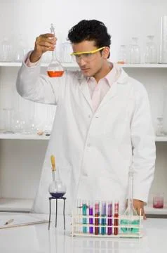 Scientist examining a flask in a laboratory Stock Photos