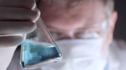 Scientist examining liquid in conical flask Stock Footage 35108212