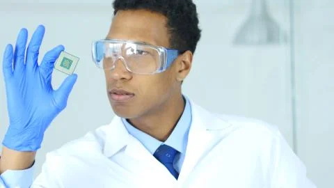 Scientist Examining, Looking on New Electronic Chip of Computer Foto stock