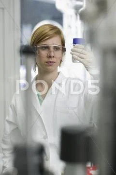 Scientist Examining Sample In Jar
