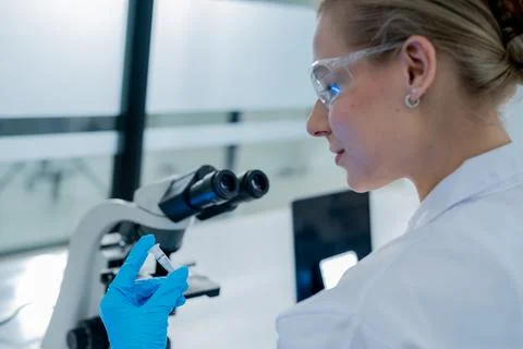 Scientist examining a sample at a modern laboratory during a research sessi.. Stock Photos