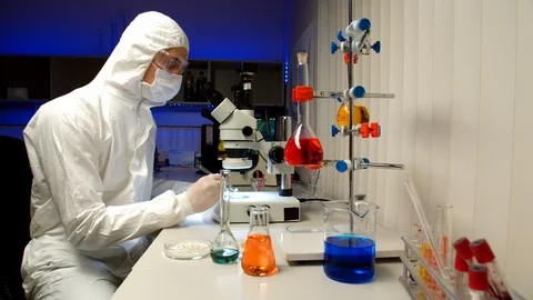Scientist examining samples with microscope Stock Footage 127562651