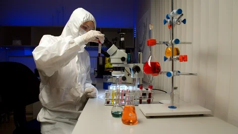 Scientist examining samples with microscope Stock Footage 127563737