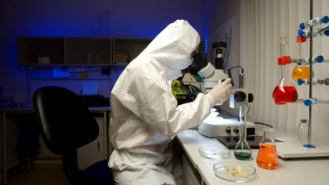 Scientist examining samples with microscope Stock Footage 127564252