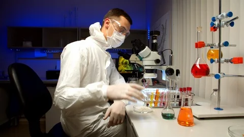Scientist examining samples with microscope Video stock 127564689