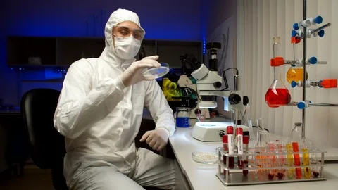 Scientist examining samples with microscope Stock Footage 127564783