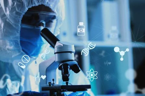 Scientist examining samples with a microscope in a laboratory during research Stock Photos