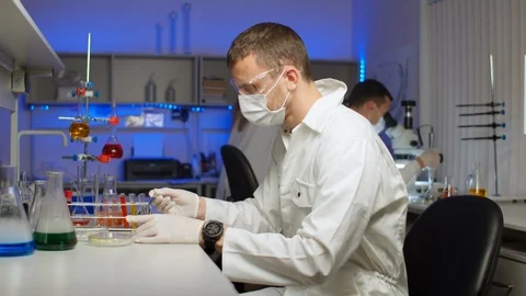 Scientist examining sprouts in Petri dish Stock Footage 127564153