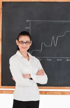 Scientist explaining a graph while looking at the camera Stock Photos
