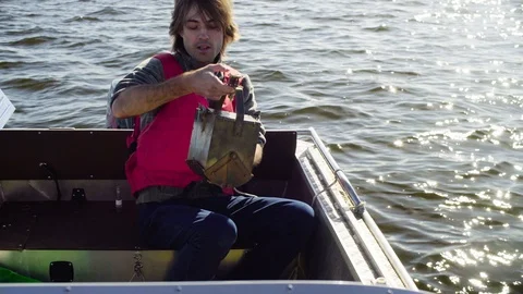 The scientist explaining how the device for taking a bottom silt is arranged 動画素材 93741131